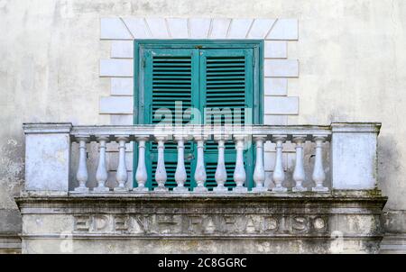Old green shutters covering a window on a stone balcony of a house in Amalfi, Italy Stock Photo