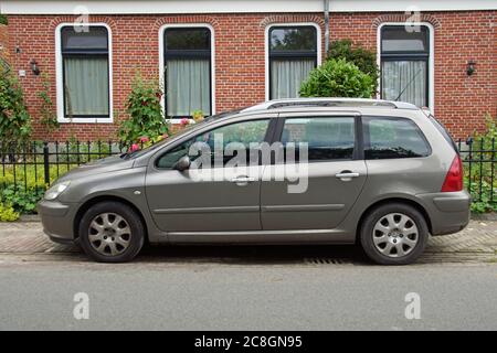Pieterburen, the Netherland - July 16, 2020: Peugeot 307 SW parked on a public parking lot. Nobody in the vehicle. Stock Photo