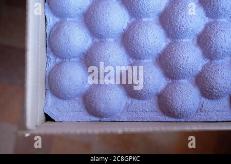 Purple packaging for the safety of the parcel. Unusual paper spacer for fixing goods. Stock Photo