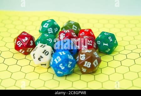 Role-playing board with several colored dice on top in a pentagonal shape Stock Photo