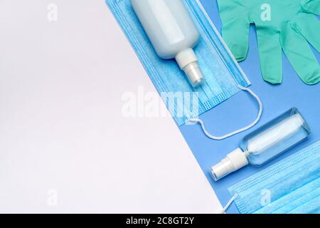 Viris protection concept - bottle of lotion, sanitizer or liquid soap, latex rubber gloves and medical protective mask Stock Photo