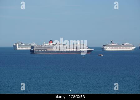Cruise ships anchor in Weymouth Bay due to the Corona Virus Pandemic. One of the notable liners is Queen Mary II Stock Photo