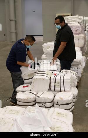 Austin, TX USA July 24, 2020:  Workers sort supplies in the Austin Convention Center while city officials are expecting a rush of COVID-19 patients as numbers of infected Texans continue to spike  The temporary field hospital is prepared to handle hundreds of mild to moderate cases that are overwhelming hospitals in the Rio Grande Valley. ©Bob Daemmrich Stock Photo