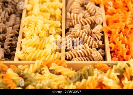 Various kind of Italian pasta in the wooden box. Stock Photo