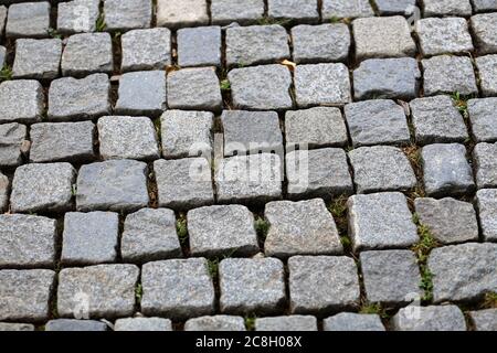 Stone pavement texture. Granite cobble stoned pavement background. Stock Photo