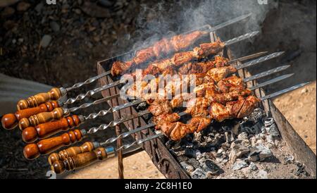 Barbecue Grilled pork kebabs meat lamb kebab marinated barbecue meat shashlik shish kebab outdoors picnic. Shashlik or Shish kebab popular in Eastern Stock Photo