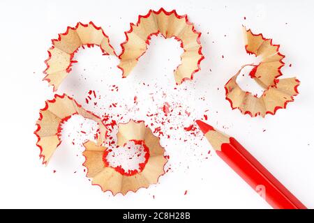 sharpened red pencil with shavings on white paper Stock Photo