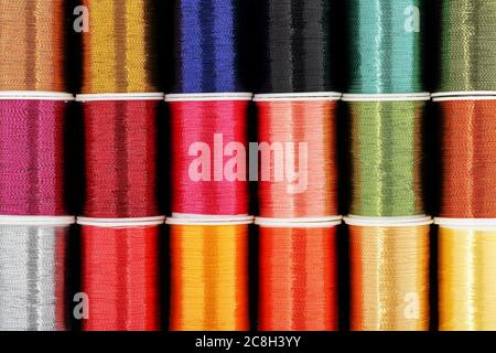 set of colorful spools of thread on a white background Stock Photo - Alamy