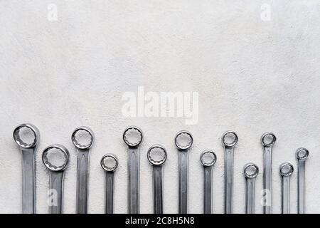 Wrench spanner tools on grunge concrete background. Top view, copy space for text. Stock Photo