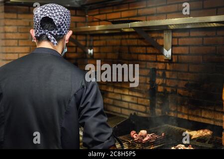 Chef grilling steaks in commercial kitchen. High quality photo Stock Photo