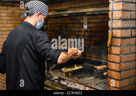 Chef grilling steaks in commercial kitchen. High quality photo Stock Photo