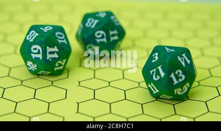 Role-playing board with three green dice on top in a pentagonal shape Stock Photo