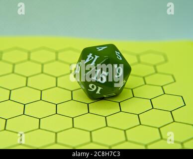 Role-playing board with green dice on top in a pentagonal shape Stock Photo