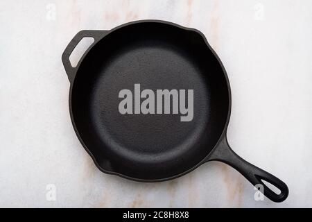 Cast Iron Skillet on Marble Countertop Stock Photo
