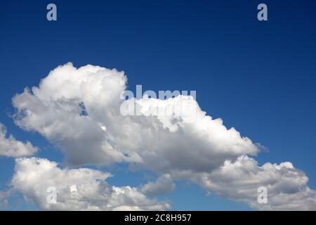 Summer typical clouds with deep blue sky Stock Photo