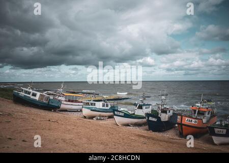 At the beach of Jaroslawiec in Poland fishing boats lie on the beach of the Baltic Sea