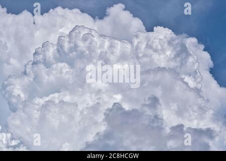 Towering Cumulus clouds forming in the sky before the onset of a thunderstorm in a tropical climate. Stock Photo