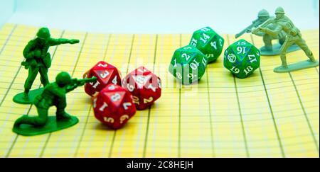 Role-playing field with pentagonal-shaped colored dice and plastic figures on top of the board Stock Photo