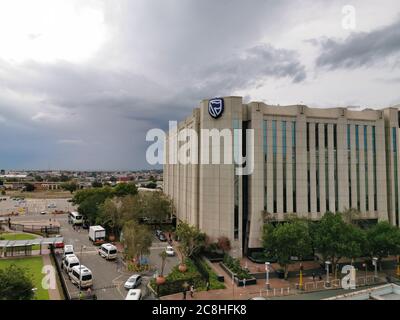 Beautiful and tall Standard bank buildings in Simmonds street Selby Johannesburg CBD area under a cloudy and sunset sky Stock Photo