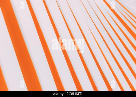 Abstract orange and white lines building. Orange pattern on white background. Geometric pattern. Wall. Construction in the city park from a certain po Stock Photo