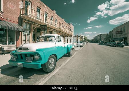 Hannibal USA - September 4 2015; Vintage Studebaker pick-up truck parked in street beside traditional architectural buildings in infrared  filmic styl Stock Photo