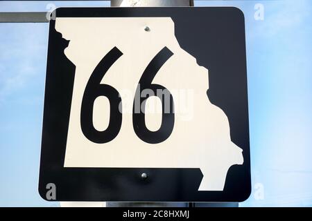 Missouri Route 66 roadsign with black route number on white cutout map of state., MO USA Stock Photo