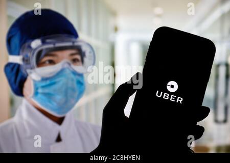 In this photo illustration an Uber app logo seen displayed on a smartphone. Stock Photo