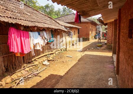 Clothes drying on the twigs and mud walls of a house in rural Maharashtra. Stock Photo
