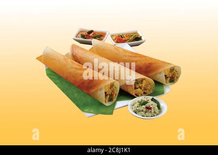 Group of South Indian food like Paper Masala Dosa (dhosa), Idli or idly, Wada or vada (Medu Vada), sambhar, sambar and coconut chutney, white backgrou Stock Photo