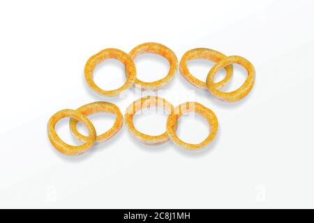 Spicy Corn Rings Snack, Fryum Onion Rings, Pile of crispy Corn ring, Cream & Onion snack, mini ring (Fryums - Frymus) isolated on white background, Sw Stock Photo