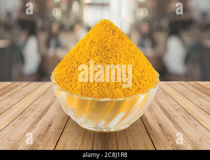 Indian spice - Turmeric Powder (Haldi) in a glass bowl with Turmeric Root white background - Image Stock Photo