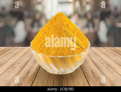 Indian spice - Turmeric Powder (Haldi) in a glass bowl with Turmeric Root white background - Image Stock Photo
