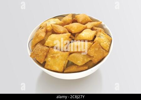 Shakkar pare Also Know as Shakkarpare, Shakarpare, Shakarpali, Shakkar Para, Sakarpara or Shankarpalli or shankar pale is a Snack Typically Made in In Stock Photo