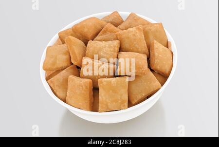 Shakkar pare Also Know as Shakkarpare, Shakarpare, Shakarpali, Shakkar Para, Sakarpara or Shankarpalli or shankar pale is a Snack Typically Made in In Stock Photo