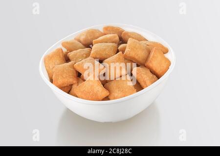 Shakkar pare Also Know as Shakkarpare, Shakarpare, Shakarpali, Shakkar Para, Sakarpara or Shankarpalli or shankar pale is a Snack Typically Made in In Stock Photo