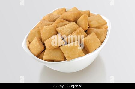 Shakkar pare Also Know as Shakkarpare, Shakarpare, Shakarpali, Shakkar Para, Sakarpara or Shankarpalli or shankar pale is a Snack Typically Made in In Stock Photo