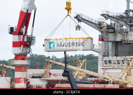 Crane unloads container ship Sevmorput - Russian nuclear-powered icebreaker lighter aboard ship carrier. Container terminal sea port. Pacific Ocean Stock Photo