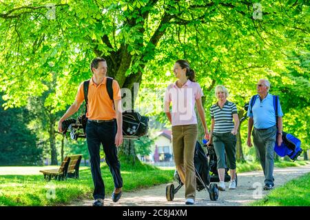 A group of golfers walking to the next tee Stock Photo