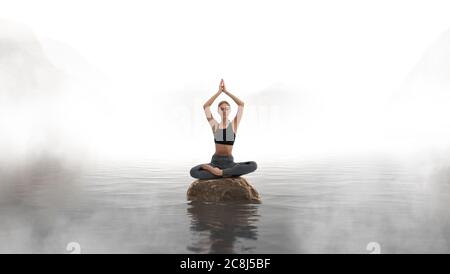 Woman is practicing yoga and meditation on the lake. Stock Photo