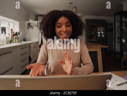 Young business woman doing video calling on laptop with partners and employees Stock Photo