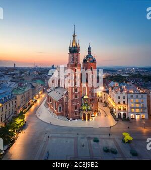 Krakow, Poland. Aerial view of illuminated St. Mary's Basilica (Bazylika Mariacka) on sunrise Stock Photo