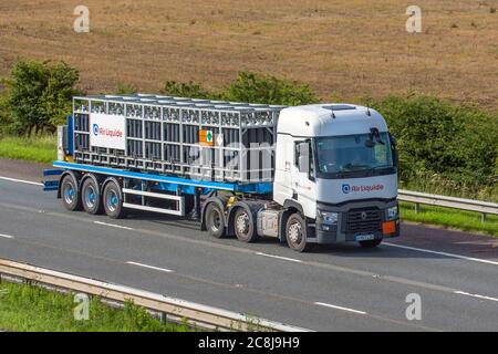 Air Liquide bottled gases, Haulage delivery trucks, lorry, transportation, truck, cargo carrier, Renault vehicle, European commercial transport, industry, M61 at Manchester, UK Stock Photo