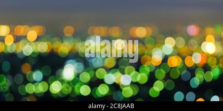 Defocus cityscape at twilight, bright and colourful blurred background with bokeh circle round lights, abstract bokeh for creative background. Stock Photo