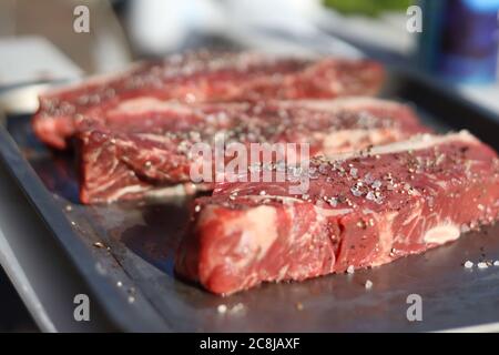 Prime steak cuts seasoned and ready for searing Stock Photo