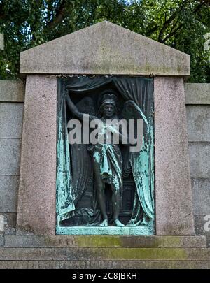 A bronze in the Dean Cemetery, Edinburgh depicting an angel pulling aside a curtain. Stock Photo