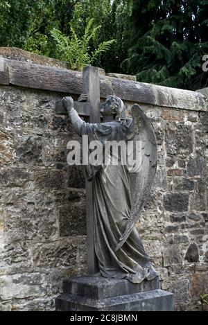 Statue of an angel holding a cross in the Dean Cemetery Edinburgh, Scotland, UK. Stock Photo