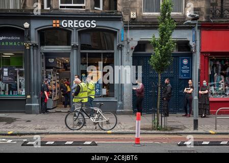 A socially distanced queue outside a branch of Greggs the bakers in the time of Covid-19 in Forrest Road, Edinburgh, Scotland, UK. Stock Photo