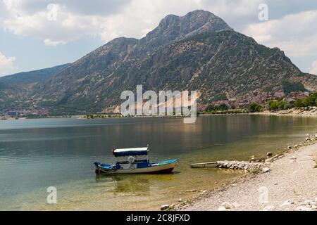 Fisher boat on Egirdir lake and Sleeping Beauty Mount (Uyuyan Guzel Dagi in Turkish) in background Stock Photo