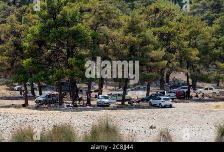 Burdur/Turkey - July 19 2020: People having picnic under trees at salda lake shore. Stock Photo