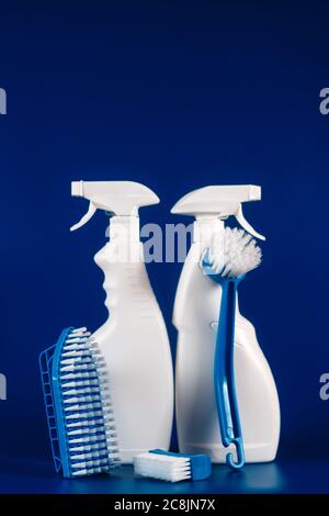 white bottles with reading fluid for glasses and brushes on a blue background, place for text. Stock Photo